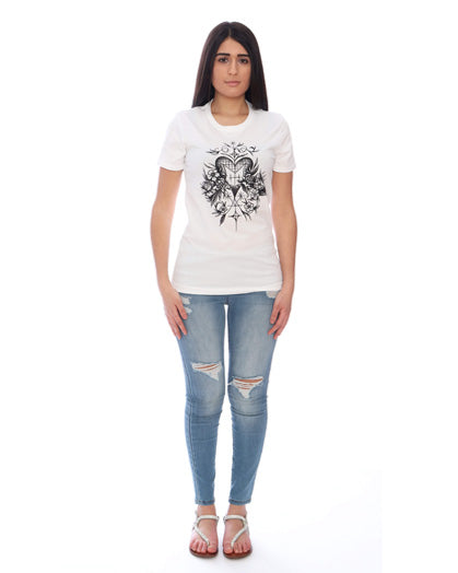 Woman wearing a white t-shirt with a graphic design and ripped jeans on a white background